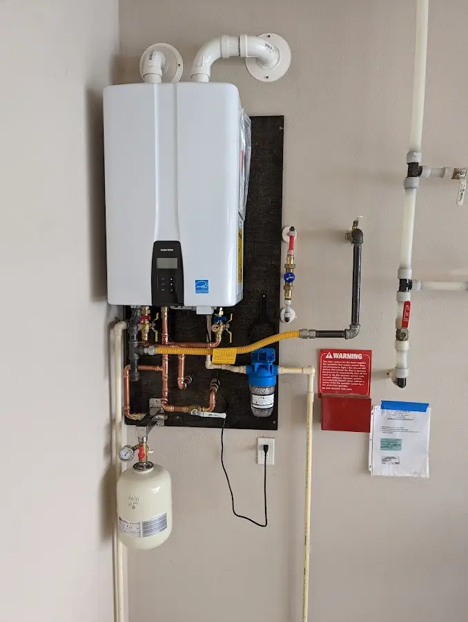 Professional plumber installing copper piping in a Maurice River home